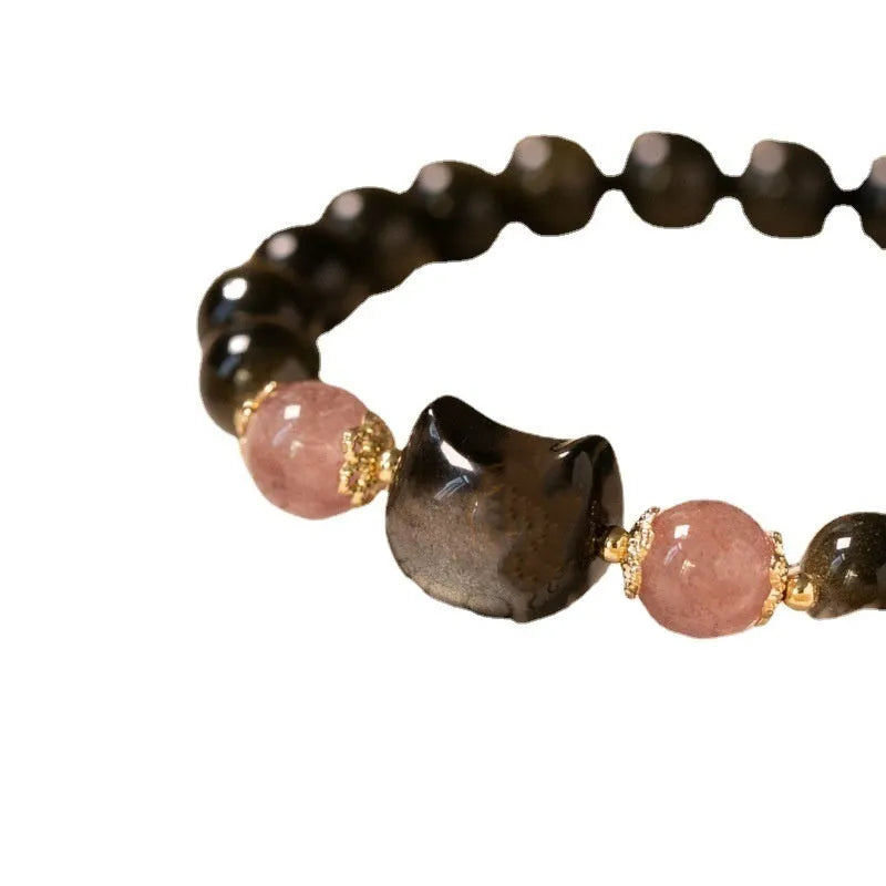 Black obsidian bead bracelet with cat charm on adjustable fastening