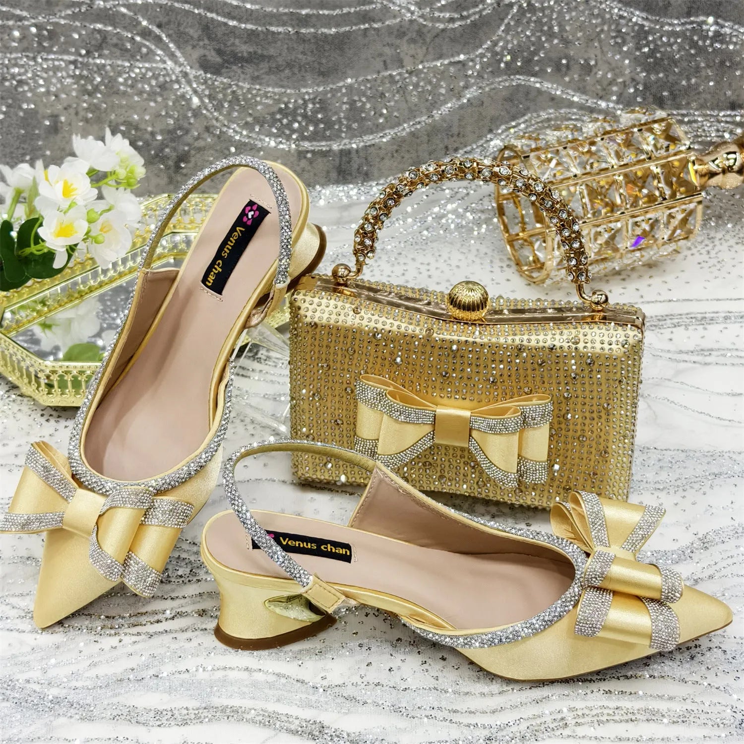 Women's pointed toe mid-heel sandals with square buckle and matching rhinestone bag in multiple colours.