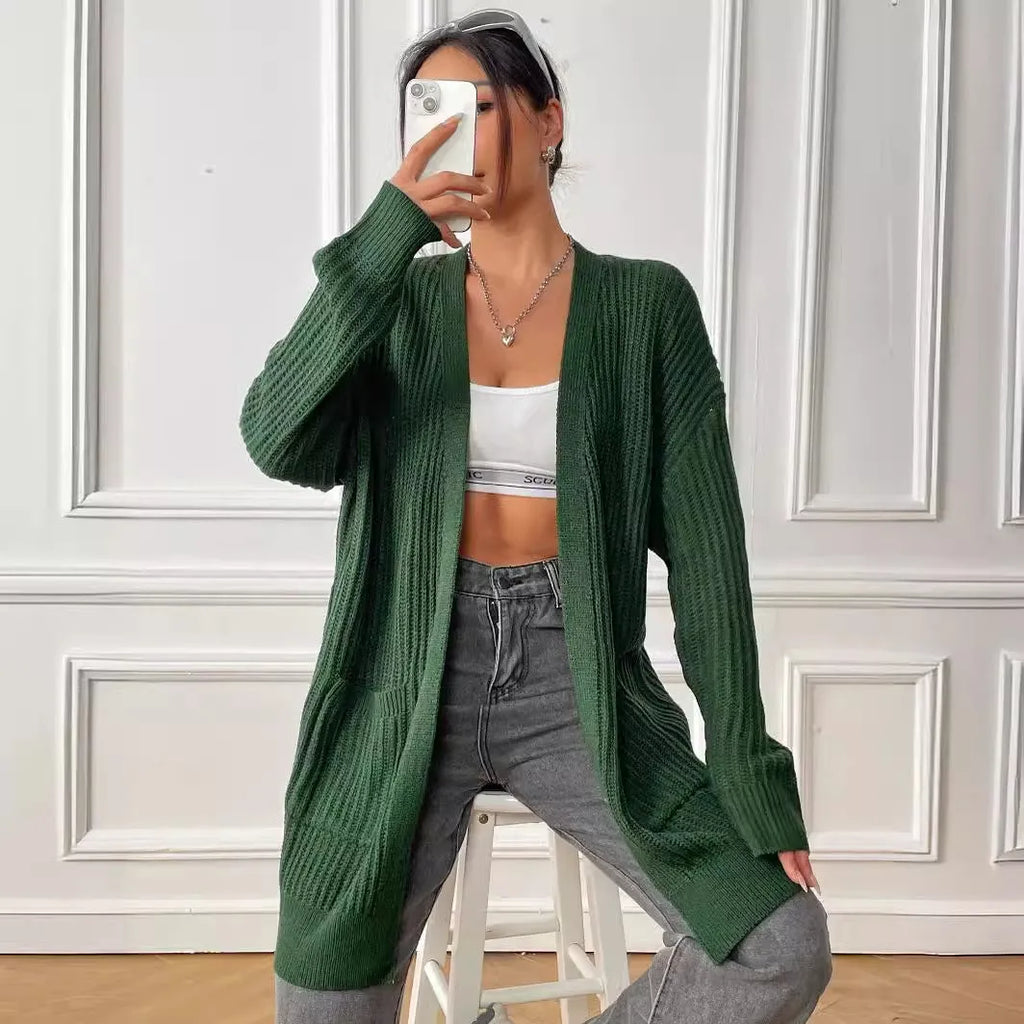A dark green loose-fit sweater cardigan with two front pockets and long sleeves.