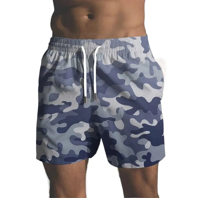 Colourful printed men's beach shorts with an elastic waistband on a neutral background.