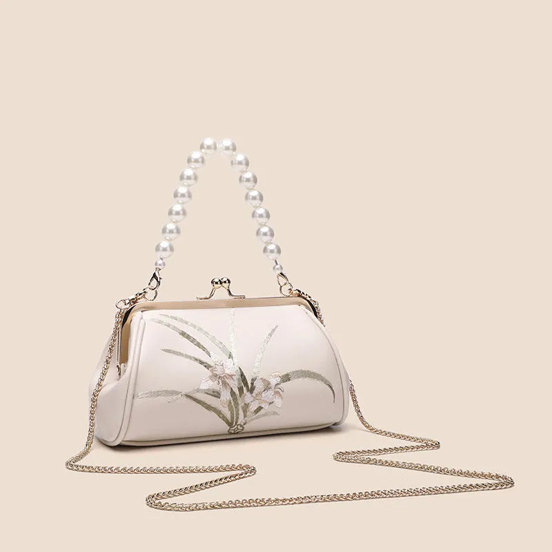 Beige women's shoulder bag with embroidery detail and shell-shaped design in soft PU leather