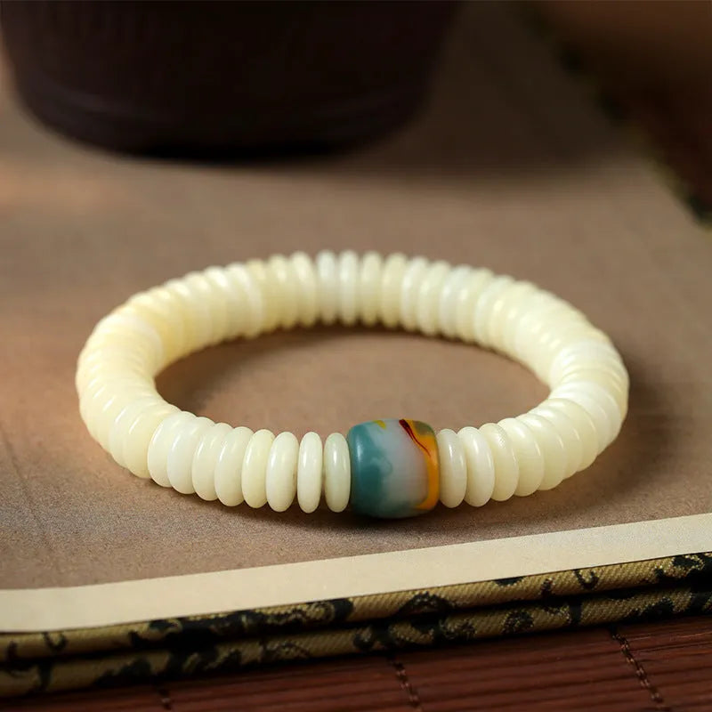 Close-up of a White Bodhi seed bracelet or handheld strand showing 3x10mm natural beads.