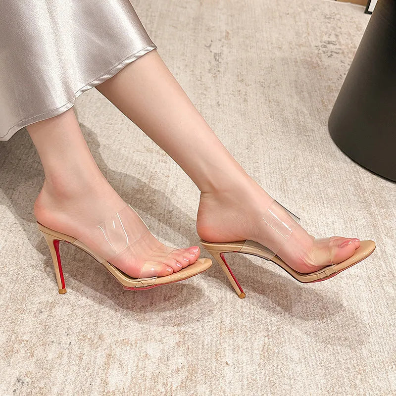 Women's transparent stiletto sandals with ankle strap in black and apricot colours, showing 8cm heel.