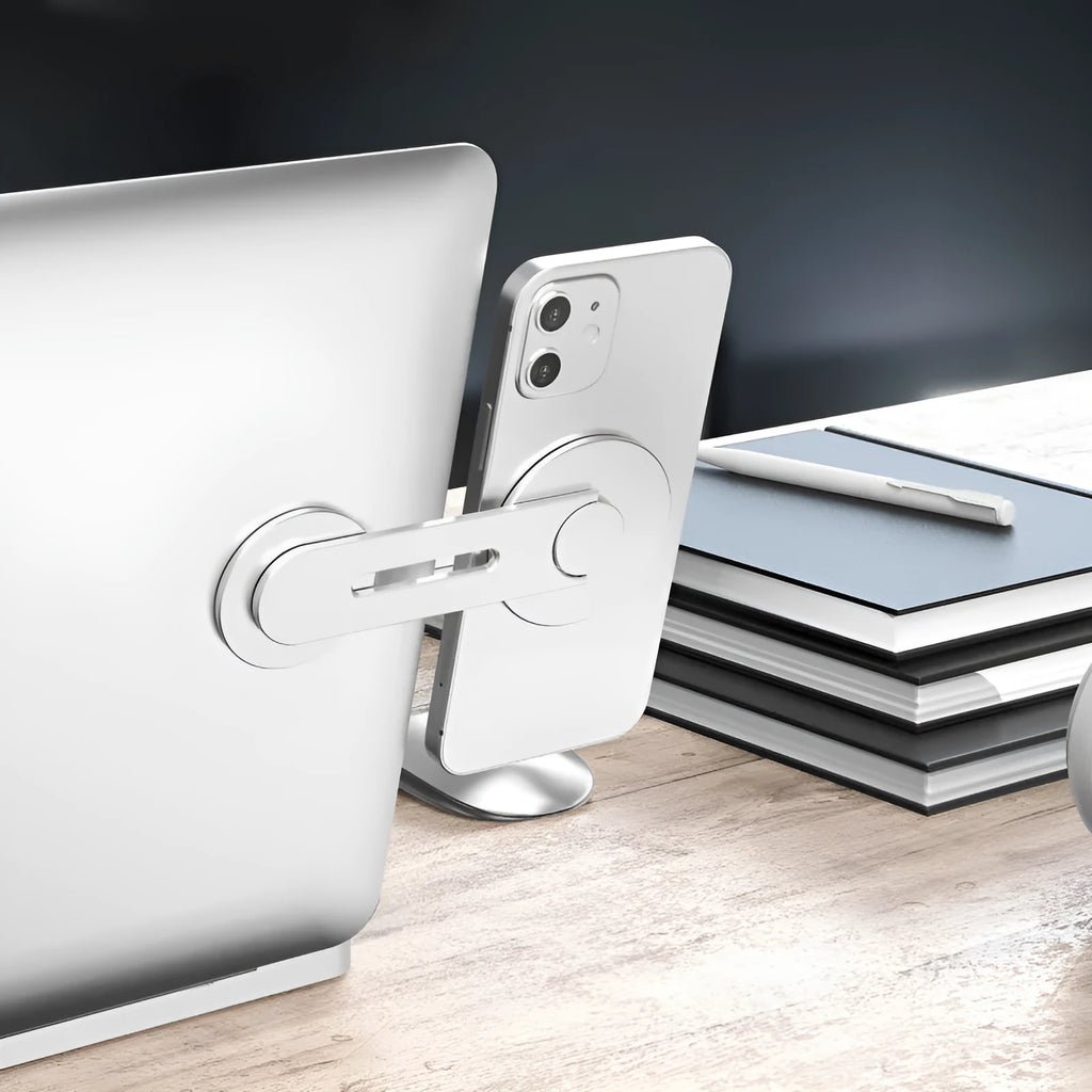 Silver aluminium alloy magnetic car phone holder with 180-degree flip rotation on a car dashboard.