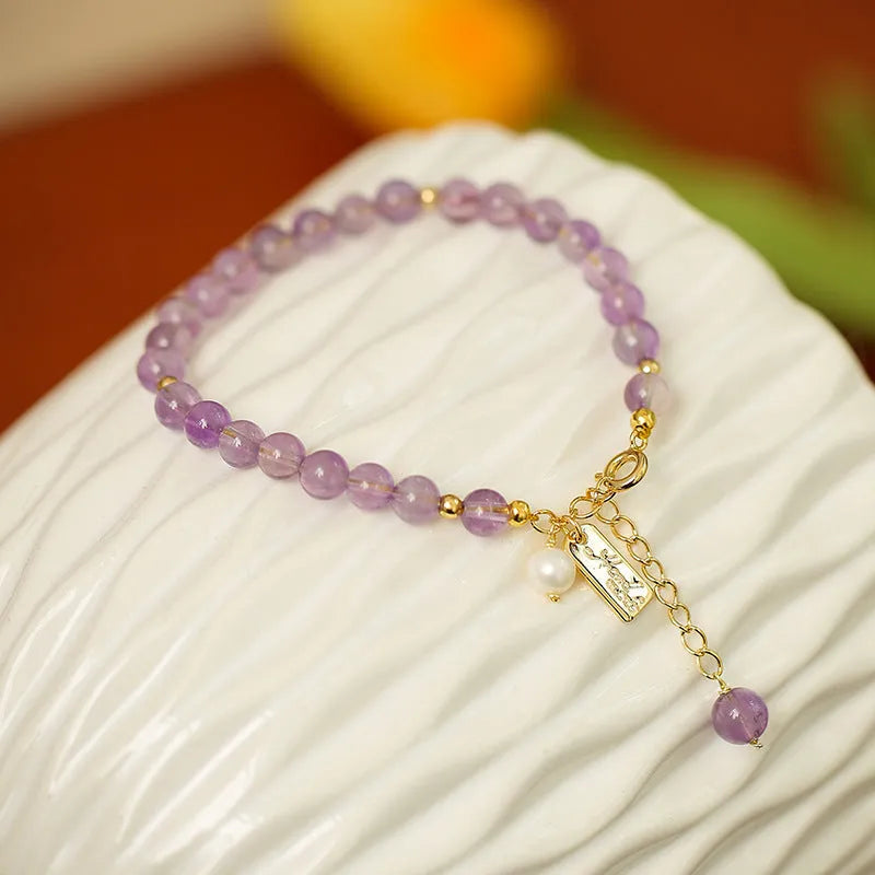 Women's lavender amethyst crystal bracelet with zodiac motif in dark and light colour options