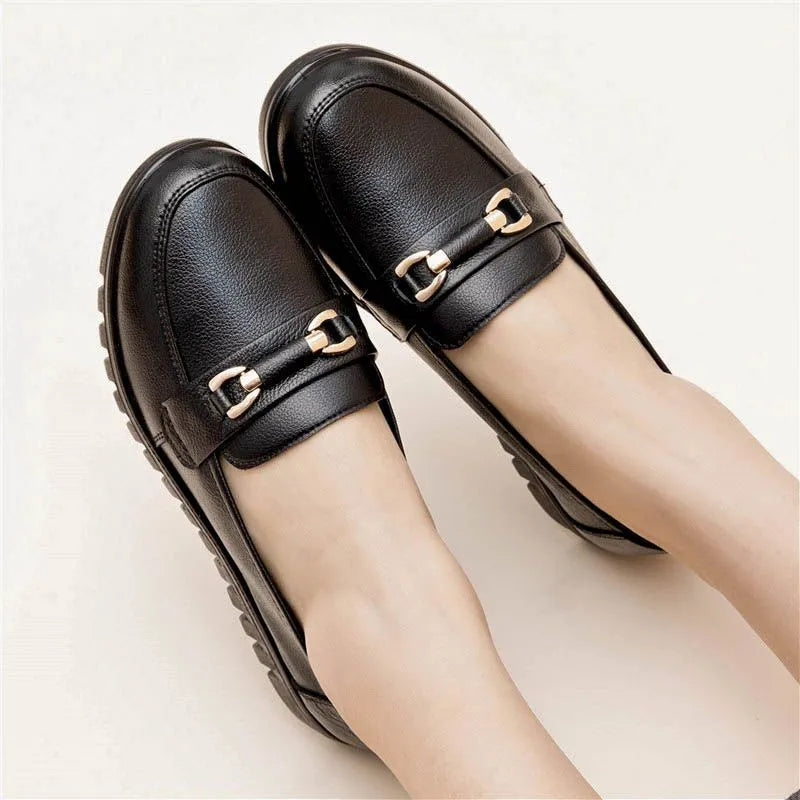 Black women's casual slip-on pumps with round toe and low flat heel on a rubber sole.