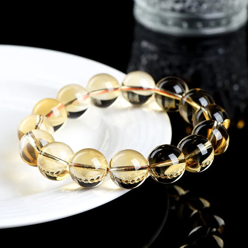 Original design bracelet with scattered, polished natural citrine beads in golden yellow tones on a wrist.