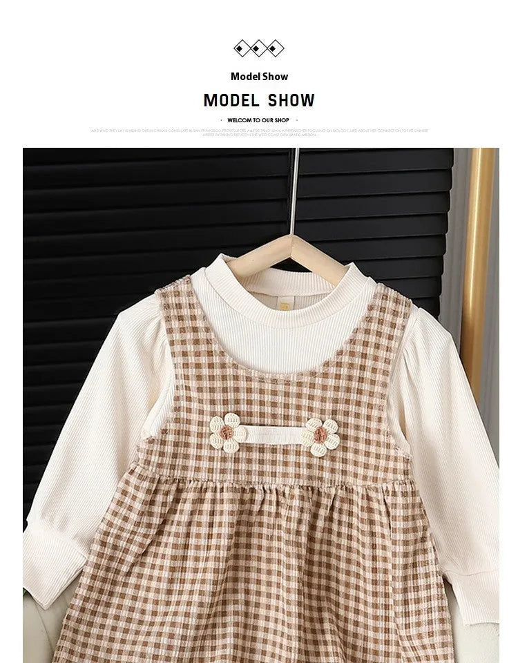 Baby girl wearing a dark coffee plaid Korean style long-sleeved dress suit set, comprising a shirt and dress.