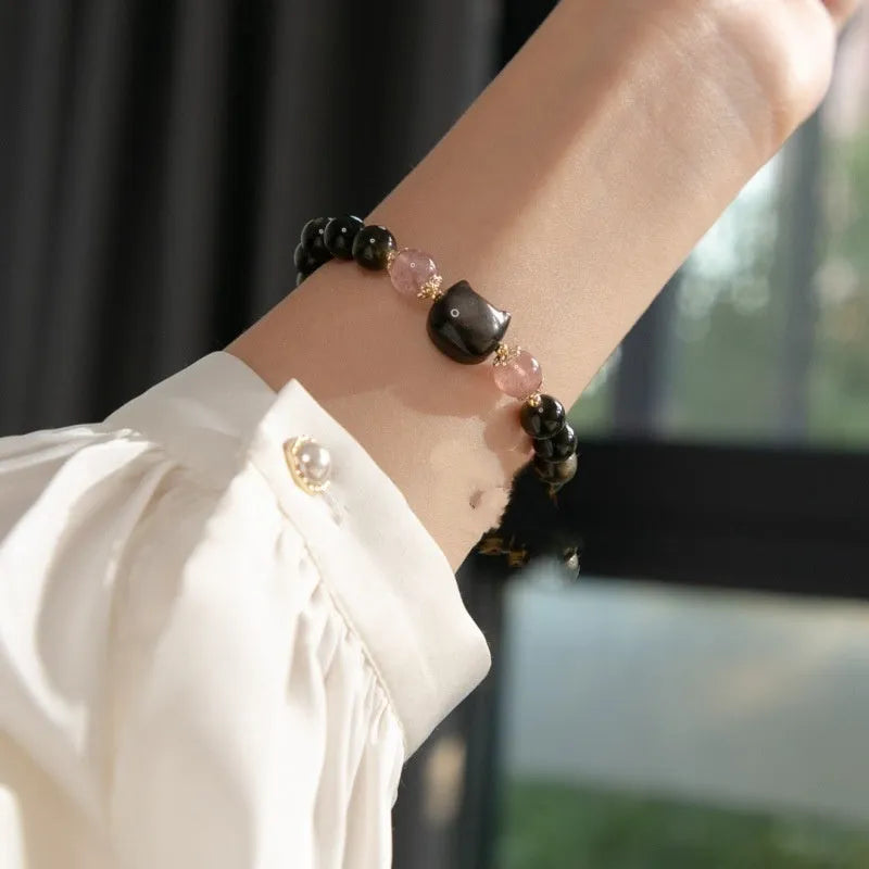 Black obsidian bead bracelet with cat charm on adjustable fastening