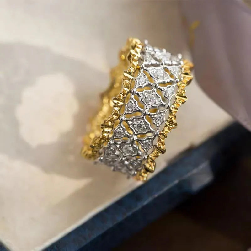 Geometric round two-tone gold zircon ring on a copper band.