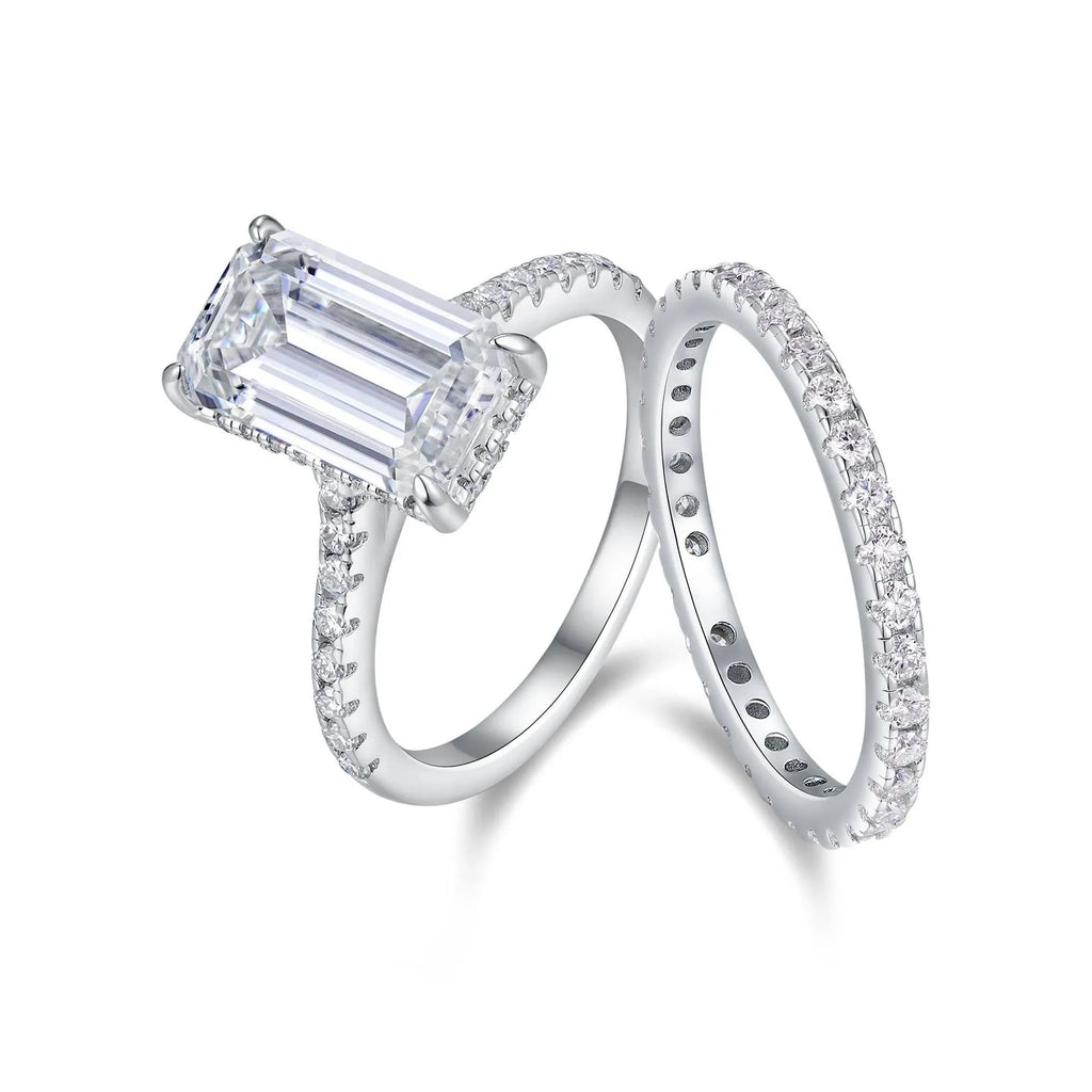 Pair of matching geometric S925 sterling silver rings with white finish on a flat surface