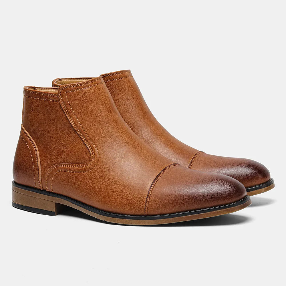 Men's brown Chelsea ankle boots with a visible side zipper on a wooden sole.