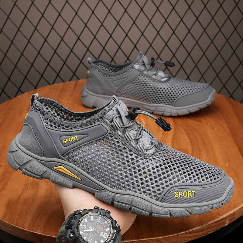 Pair of breathable outdoor sandals with leather mesh upper, flat heel, and round toe in gray, black, and khaki colours