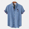 A loose-fit linen short-sleeve shirt with a blue and white ocean fish pattern, laid flat.