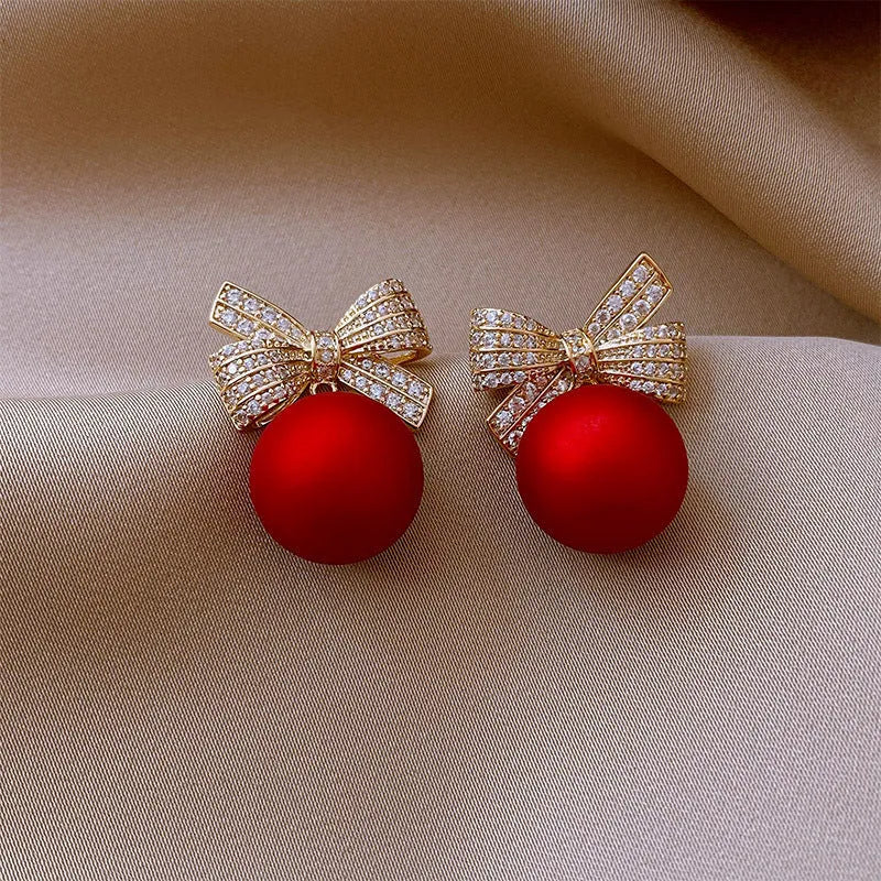 Women's bowknot stud earrings with rhinestone detail in Blue Pink Red White, alloy electroplated, individually packed.
