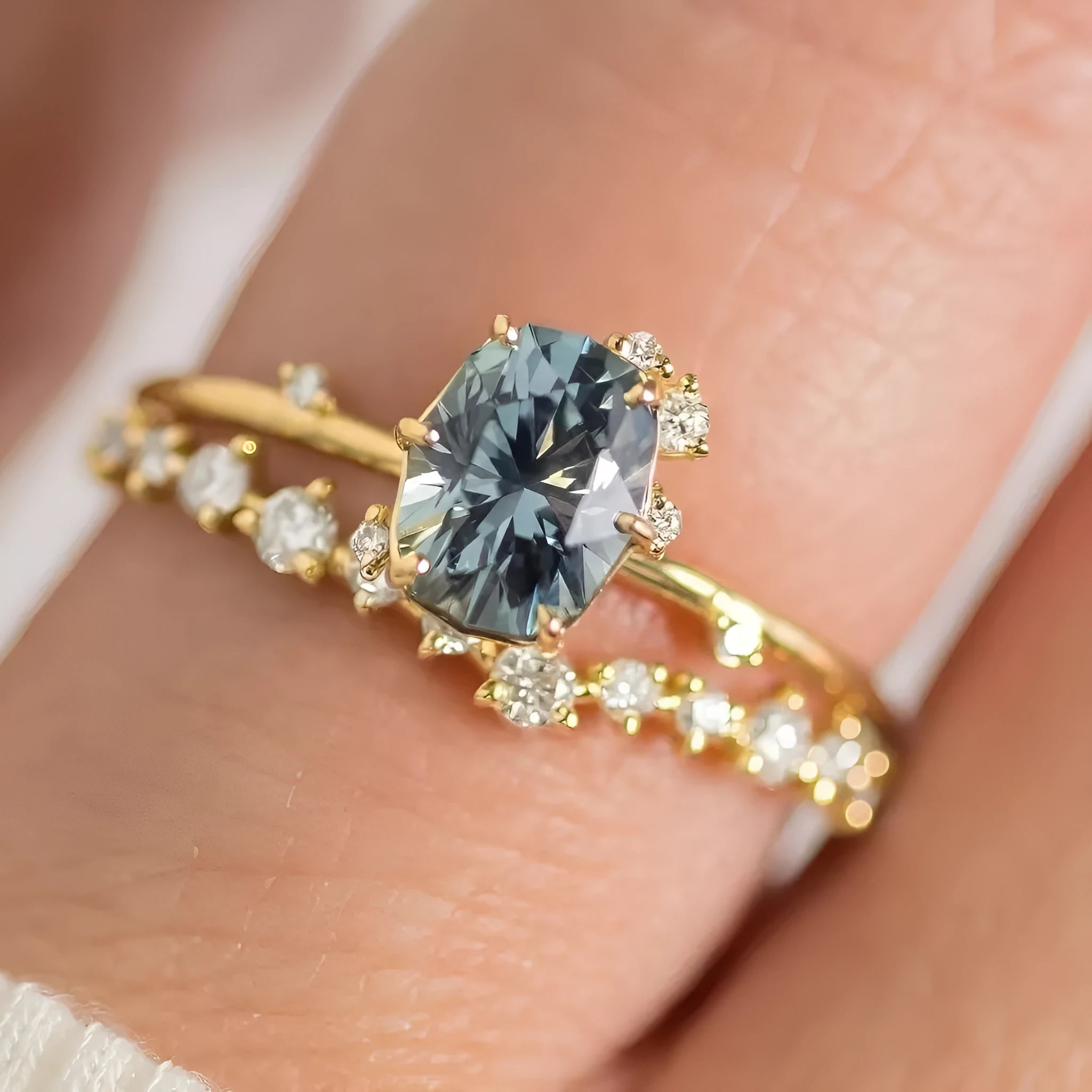 Women's gold floral ring with a green zircon stone, shown as a pair.
