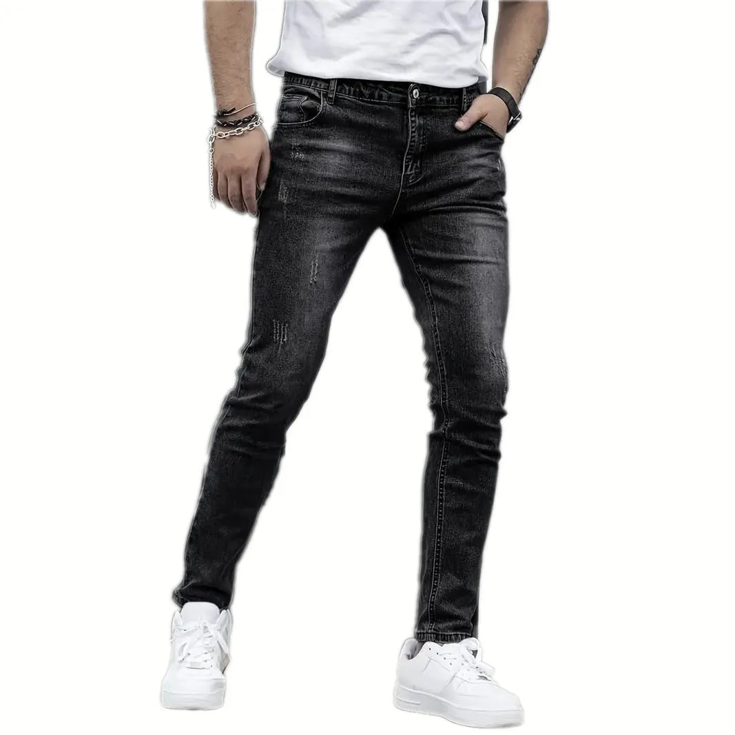 A pair of men's solid colour stretch jeans in a straight leg skinny fit, shown in dark blue.