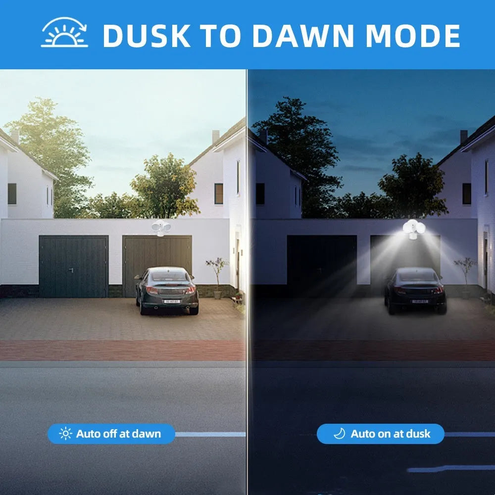 White outdoor LED security flood light with PIR motion sensor mounted on a wall beside a garage door.
