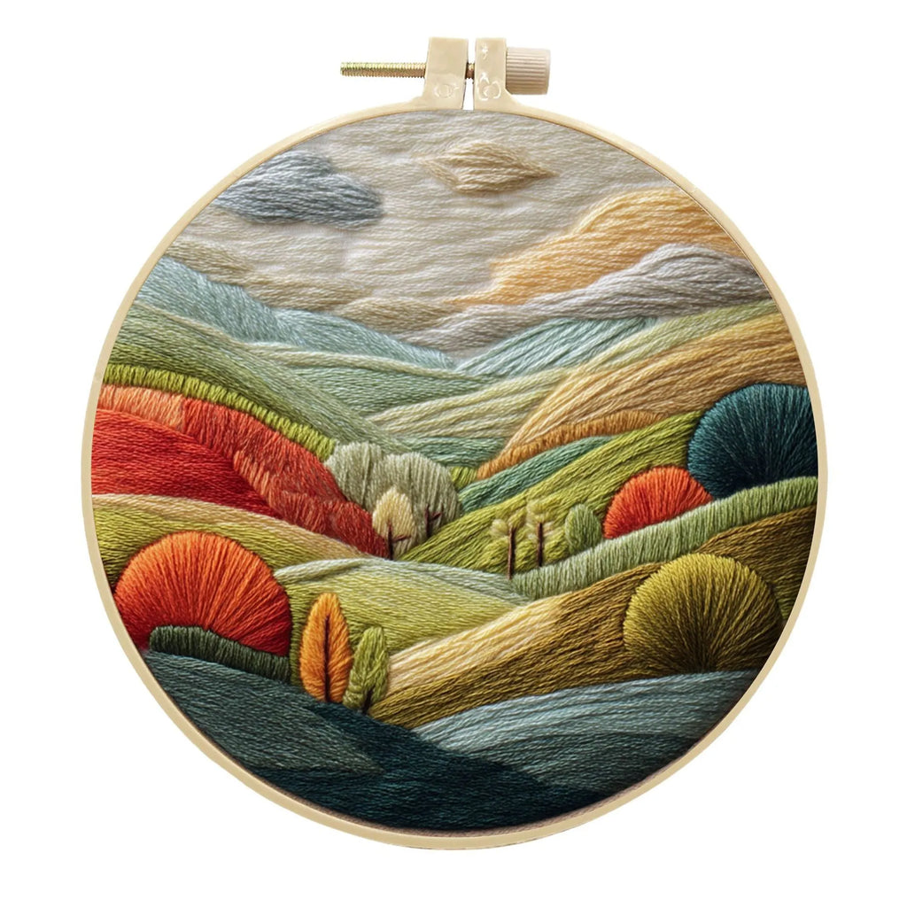 Embroidery DIY kit with landscape-printed cotton fabric, embroidery threads, and needles for handmade cloth art