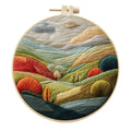 Embroidery DIY kit with landscape-printed cotton fabric, embroidery threads, and needles for handmade cloth art