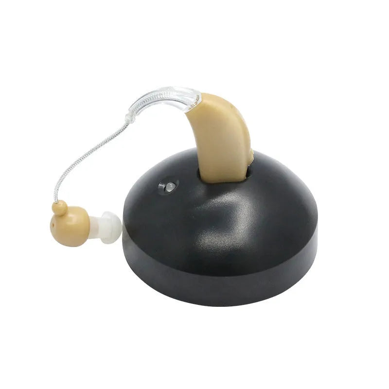 Black rechargeable hearing aid amplifier with silicone earplugs and a charging cable.
