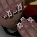 Set of 24 short, square, white-tipped French manicure false nails and a tube of nail glue on a pink background.