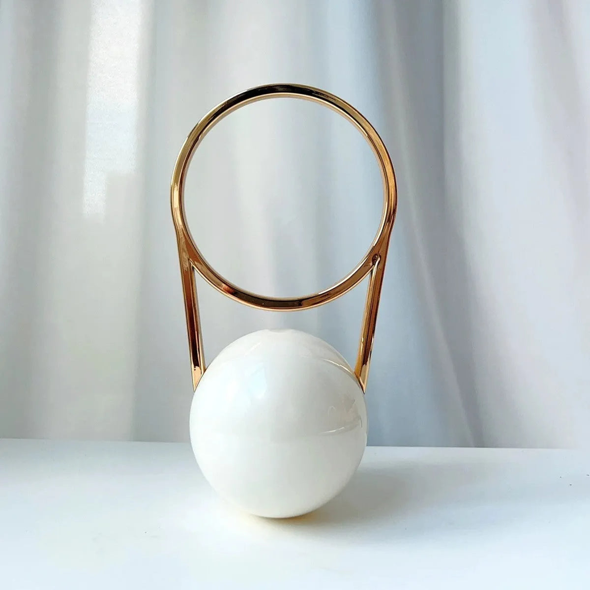 Round PVC dinner bag with electroplating handle and stitching detail in gold, measuring 25x11x15cm