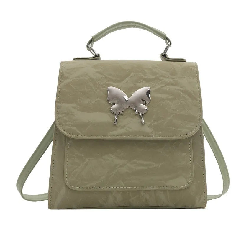 Women's white PU leather hand-carry backpack with bow detail and mobile phone compartment