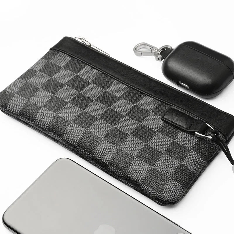 Black men's leather clutch wallet showing plaid lining, closed view