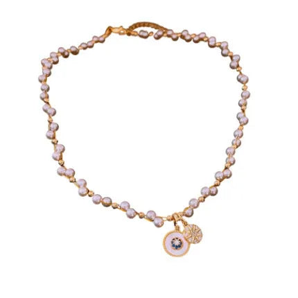 Gold electroplated round pendant necklace with zircon accents on clavicle chain