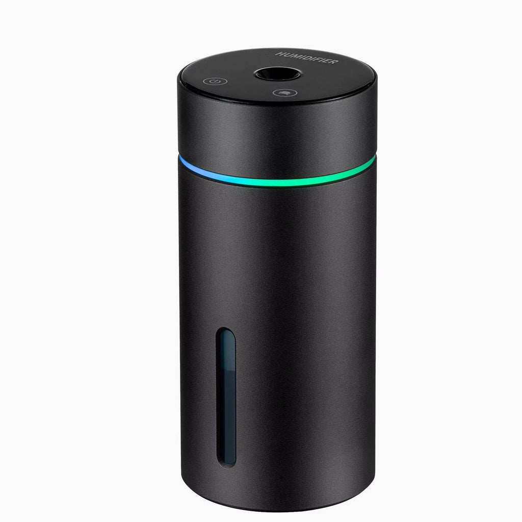 Black aluminium portable car humidifier and essential oil diffuser with USB cable on a desk.
