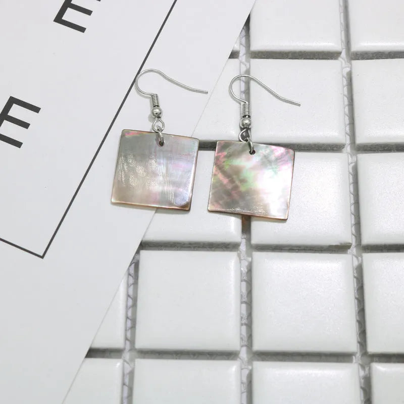 Women's natural shell earrings in geometric square and rectangular shapes with retro styling