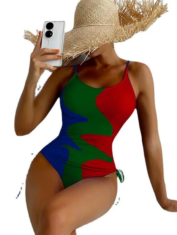 Women's blue sleeveless backless one-piece swimsuit with a striped print on a mannequin.
