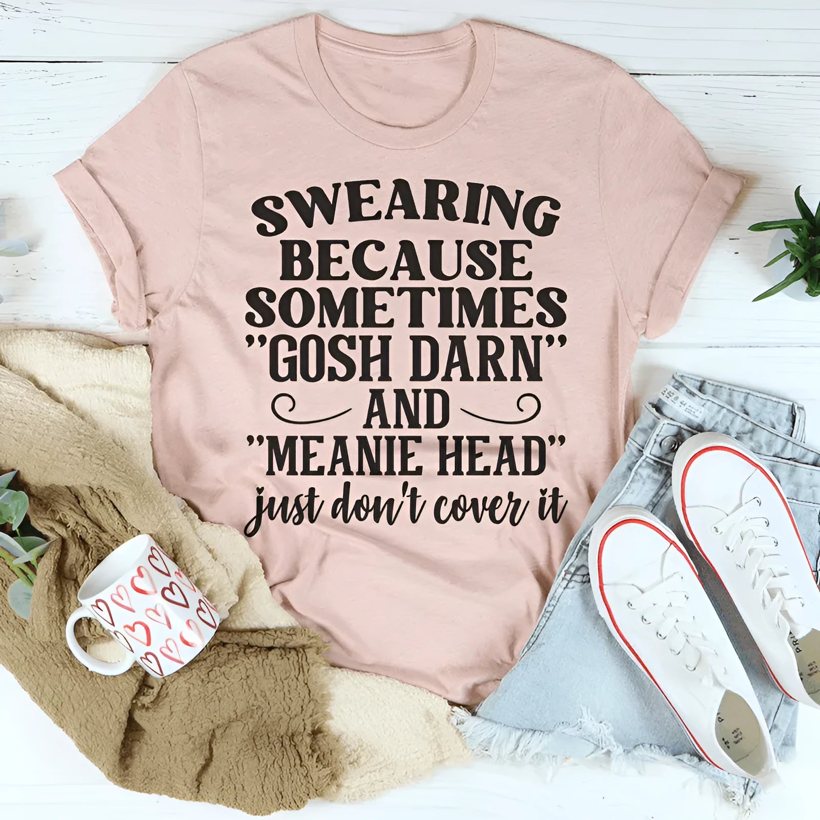 A plain pink short-sleeve T-shirt on a hanger, showing a straight, casual fit.