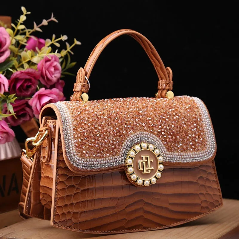 Patent leather diamond portable shoulder bag in black, brown, pink, and red with lock detail and single strap