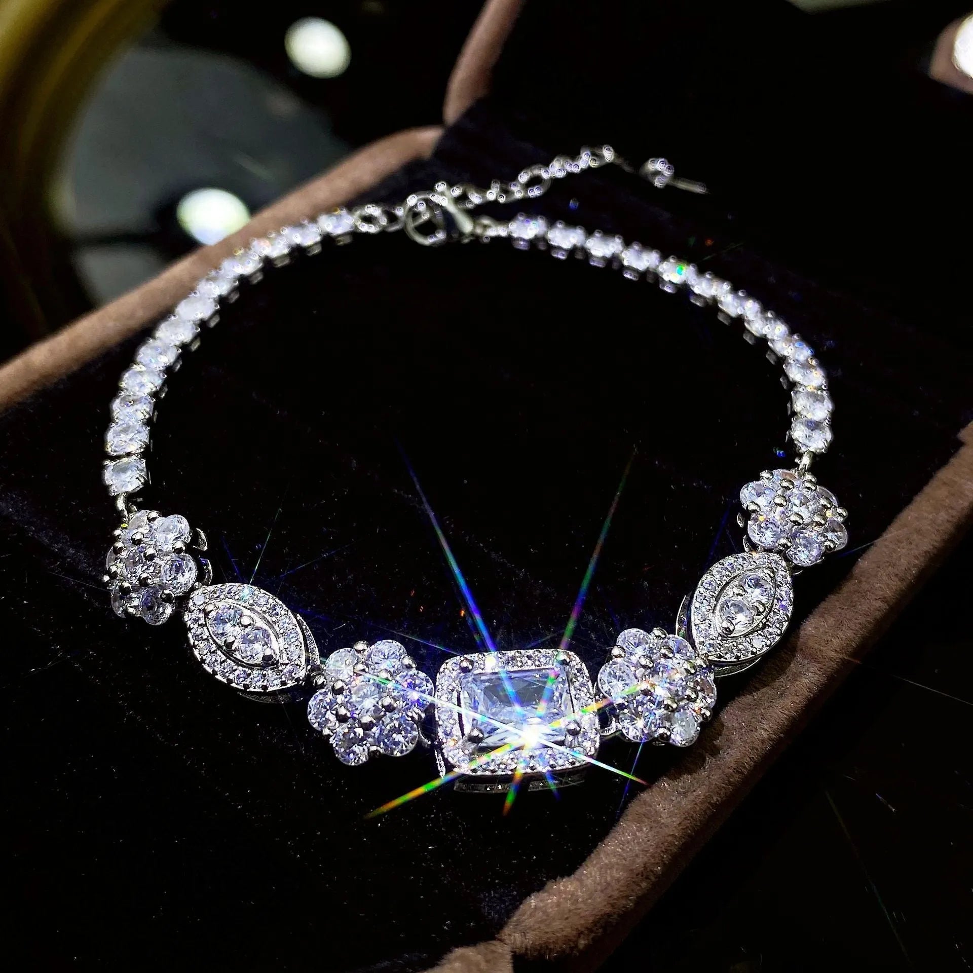 Women's geometric silver bracelet with adjustable chain and sparkling zircon stone on a wrist.
