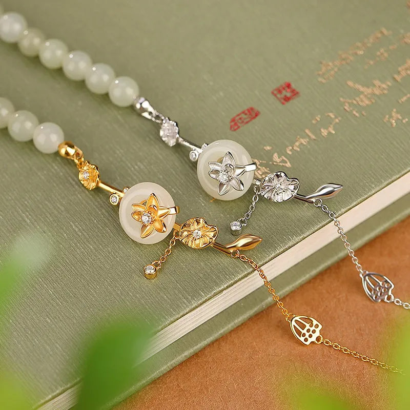 Women's 925 silver bracelet with inlaid Hetian jade centrepiece and ornate lotus peace buckle design.