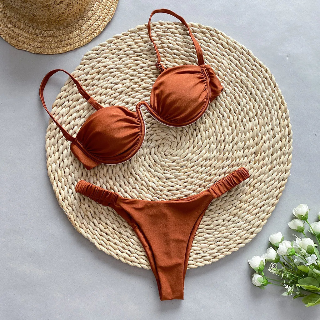 Women's black underwire bikini swimsuit set on a model, showing brief-style fit.