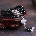 Black and red agate stone bracelet with 108 geometric beads on a wrist