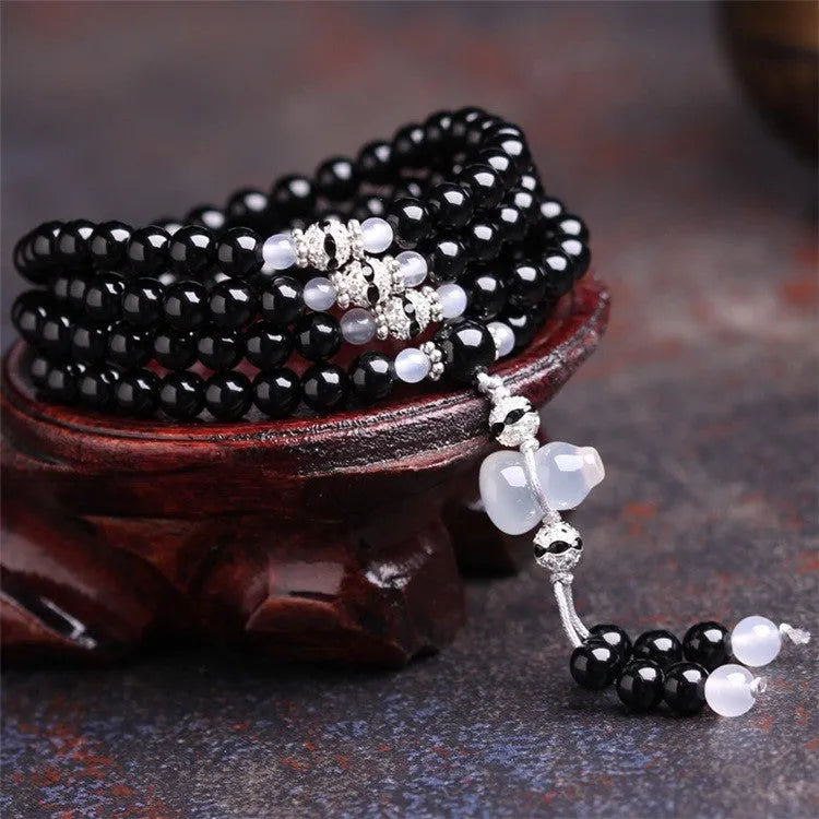 Black and red agate stone bracelet with 108 geometric beads on a wrist