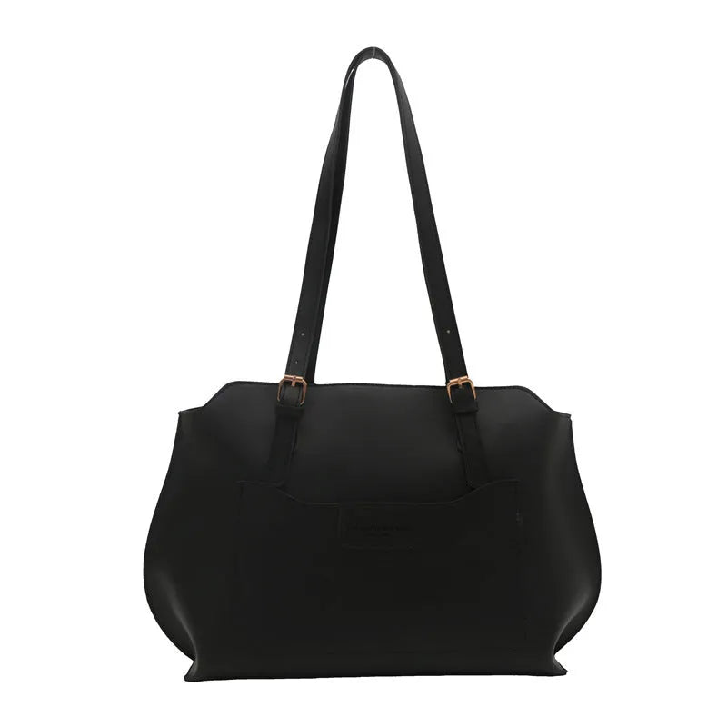 Women's square PU tote bag in black with double straps, showing external sandwich pocket and sewing line detail.