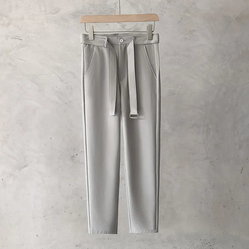Boys slim straight wool trousers in tapered fit, shown in black, on a hanger.
