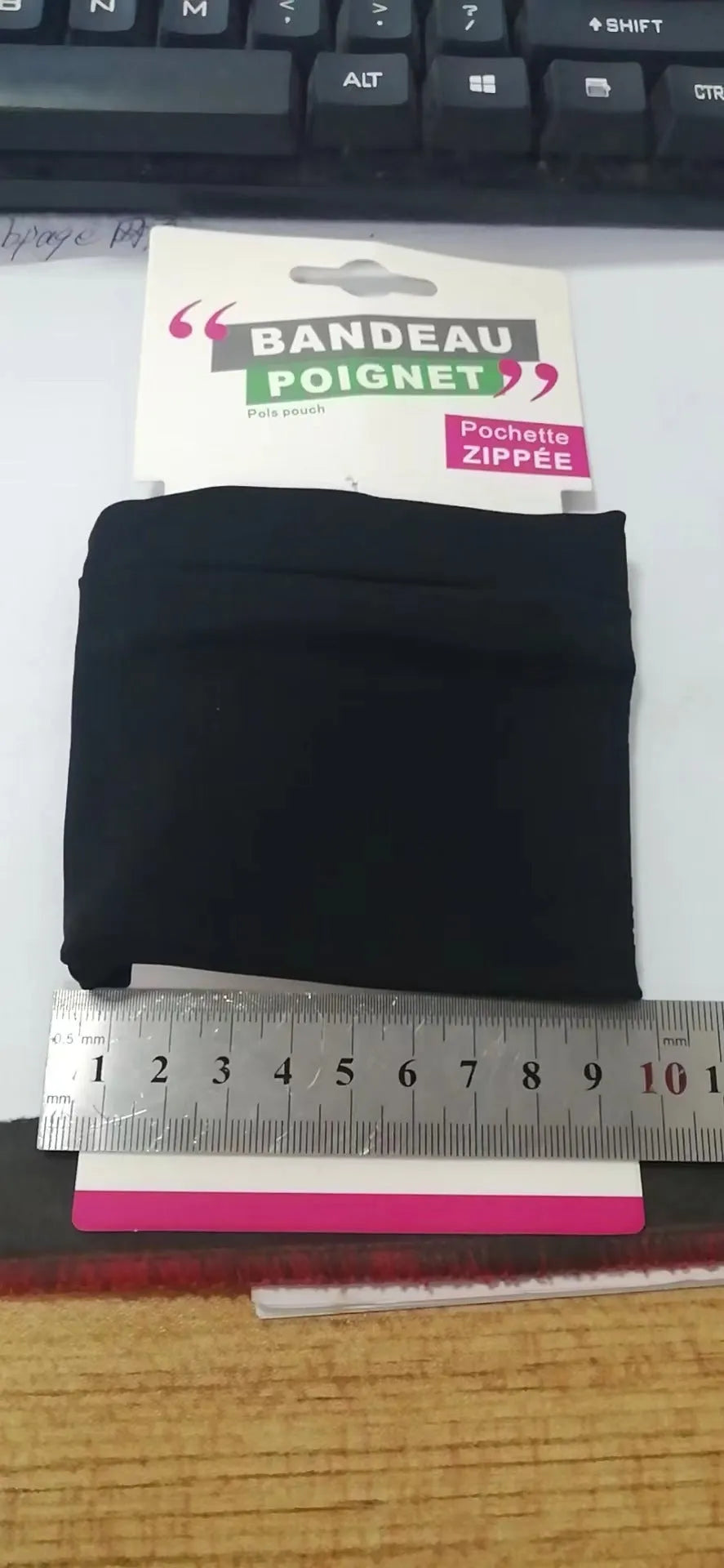 Wrist bag armband sleeve showing 10cm by 10.5cm phone compartment and protective packaging.