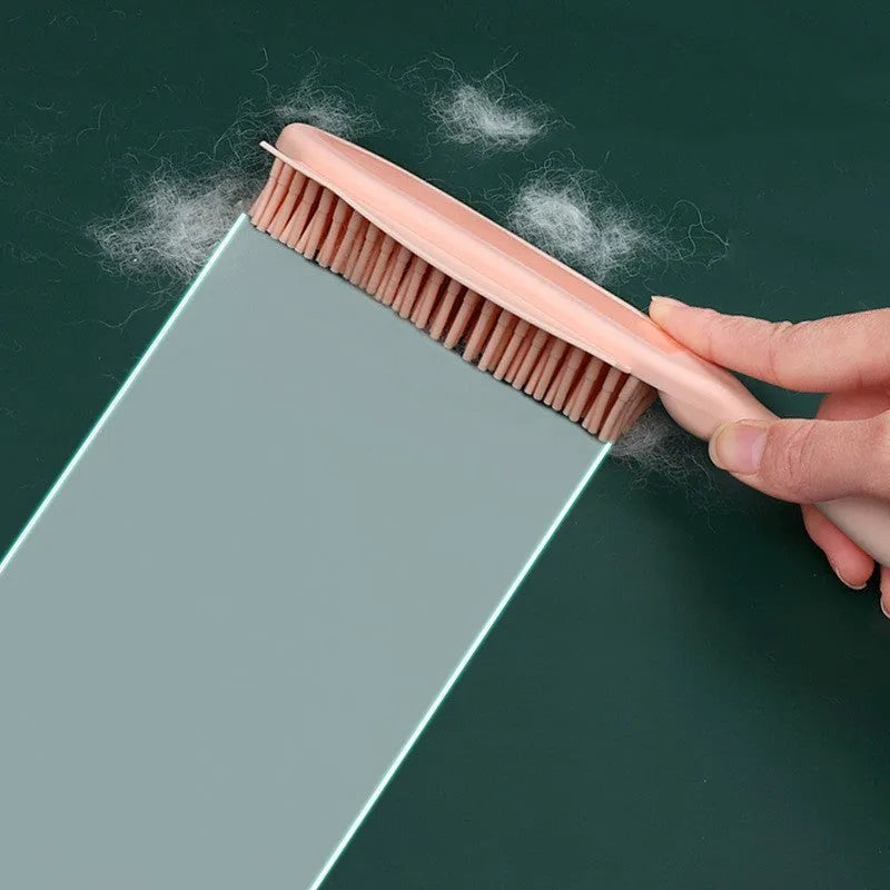 Green and pink dual-use dog brush and sticky clothes hair remover for pet grooming.