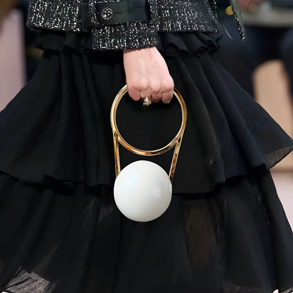 Round PVC dinner bag with electroplating handle and stitching detail in gold, measuring 25x11x15cm