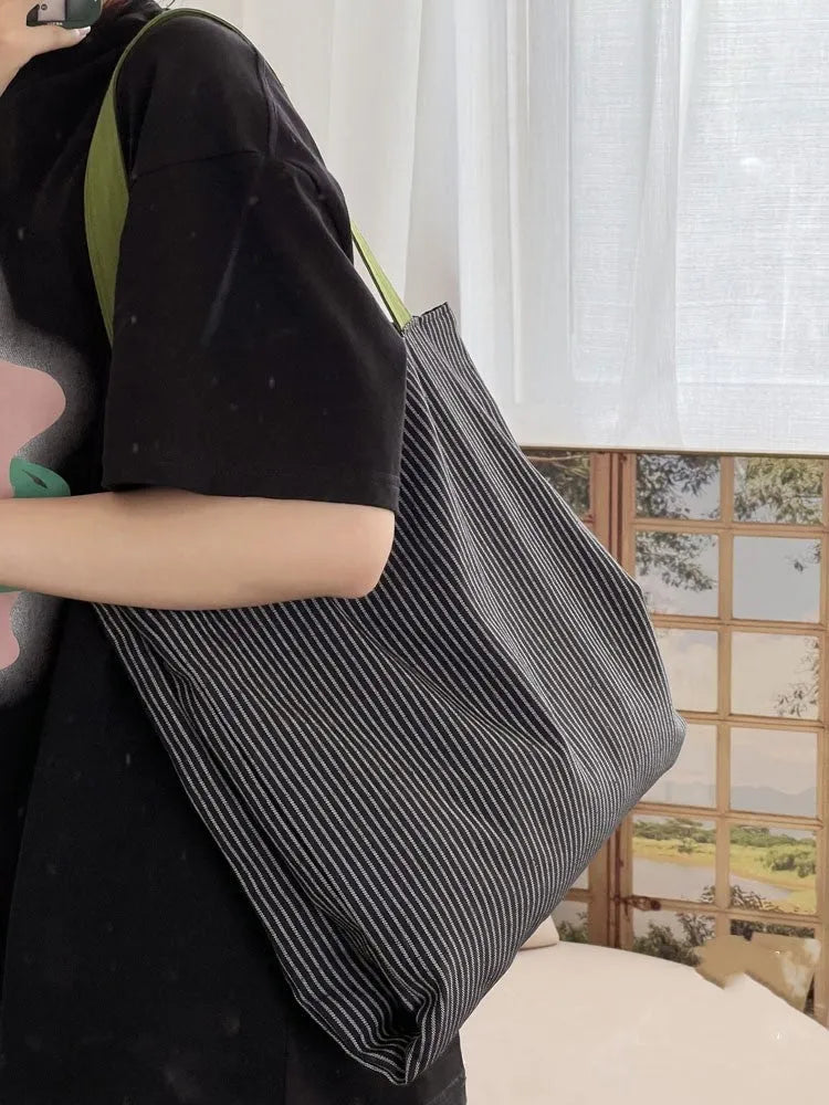 Cotton canvas multi-layer tote shoulder bag in plaid or striped pattern options with wide straps.