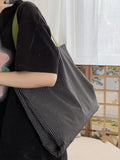 Cotton canvas multi-layer tote shoulder bag in plaid or striped pattern options with wide straps.