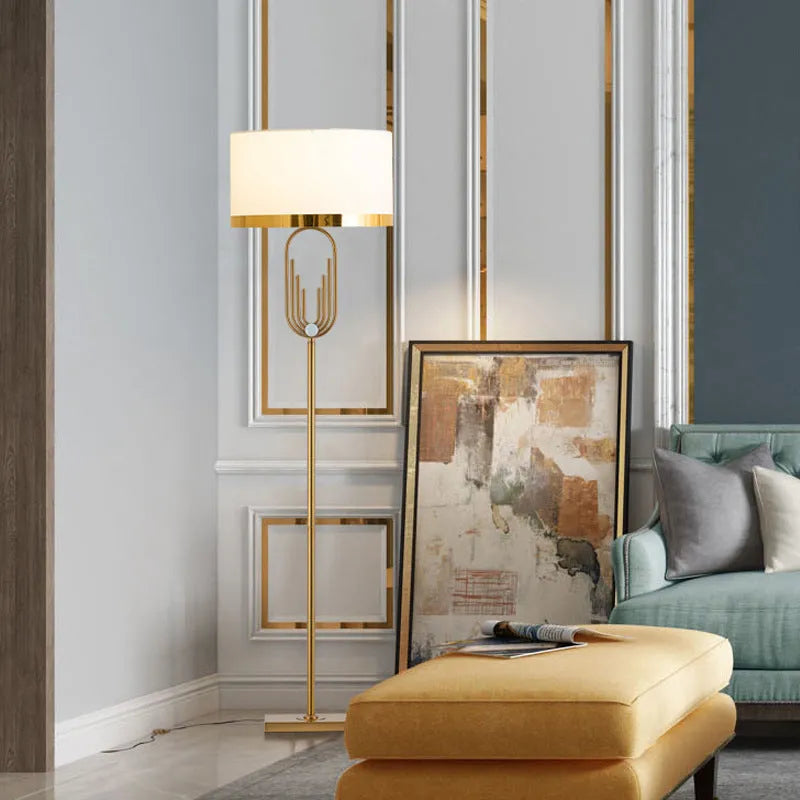 Modern silver floor lamp with adjustable height mechanism and fabric shade, remote control on side table