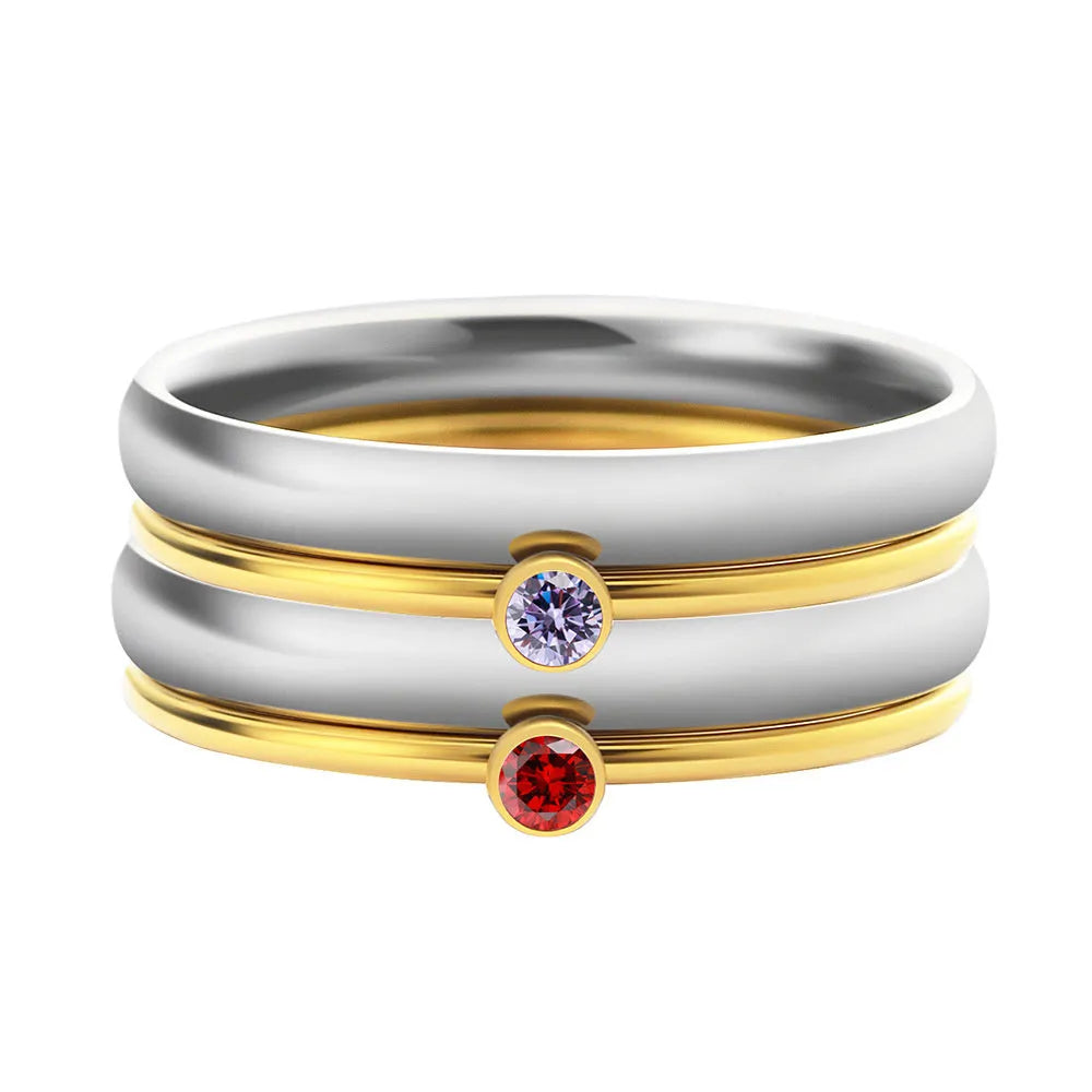 Gold tone titanium steel ring with a December birthstone in an engraved geometric design.