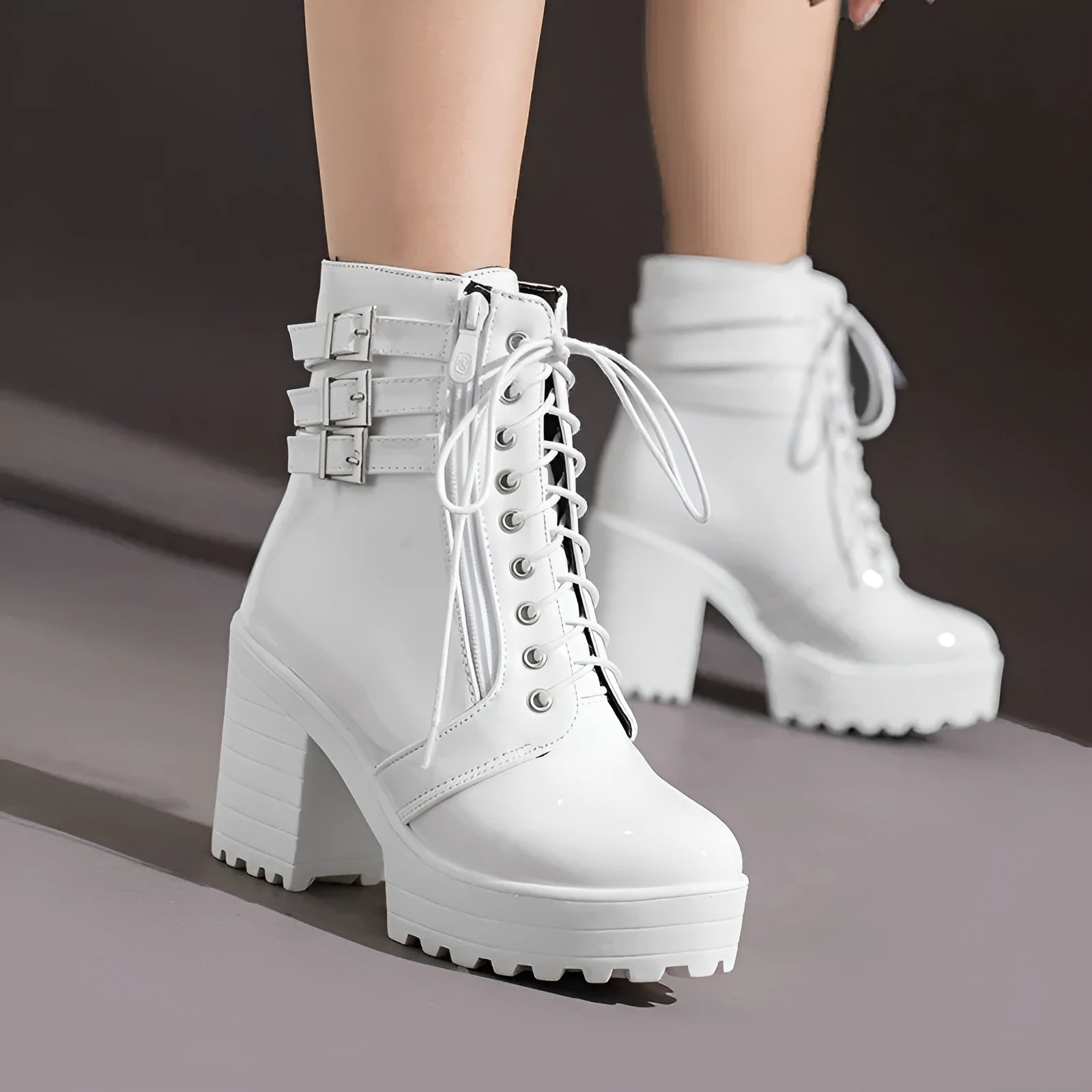 Women's black thick-heeled ankle boots with a lace-up front and waterproof platform on a rubber sole.